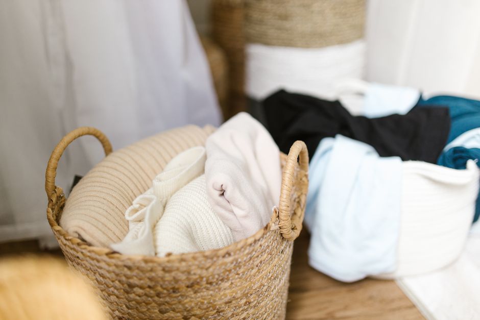 Soft clothes neatly organized in woven laundry baskets, creating a cozy and tidy indoor setting.