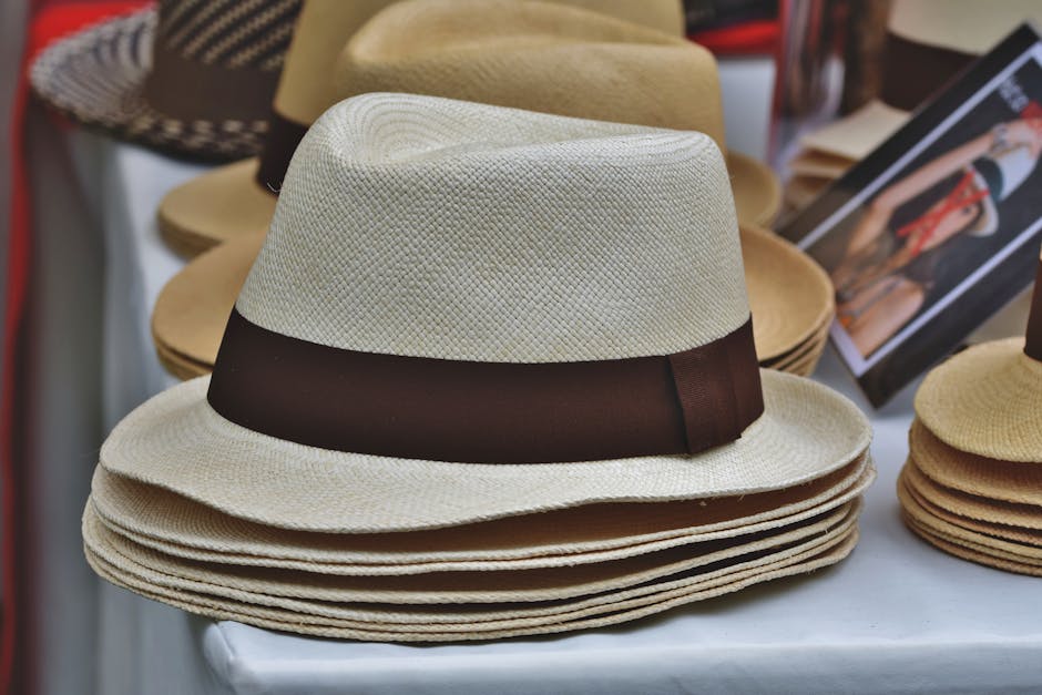 Close-up of a neatly stacked array of fedoras at a market stall. Perfect for fashion or retail concepts.