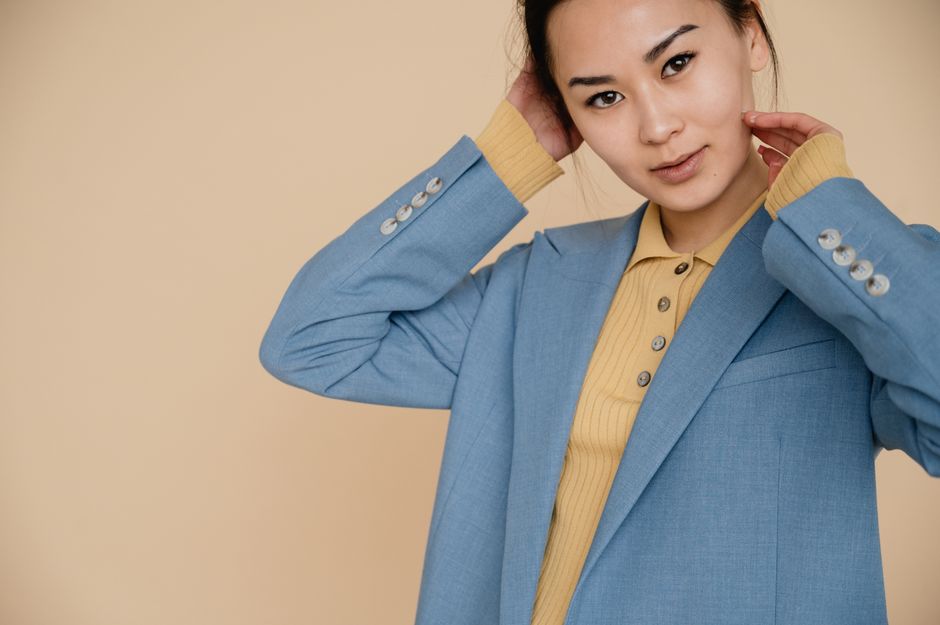Portrait of an elegant Asian woman in a blue blazer, exuding fashion and confidence.