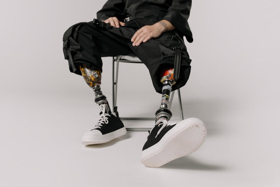 Stylish prosthetic legs with black sneakers captured in a modern studio setting.