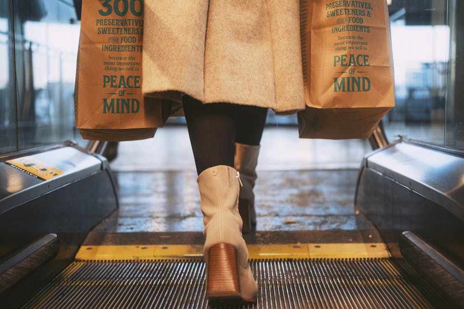 Woman carrying eco-friendly paper bags on escalator. Sustainable shopping concept.